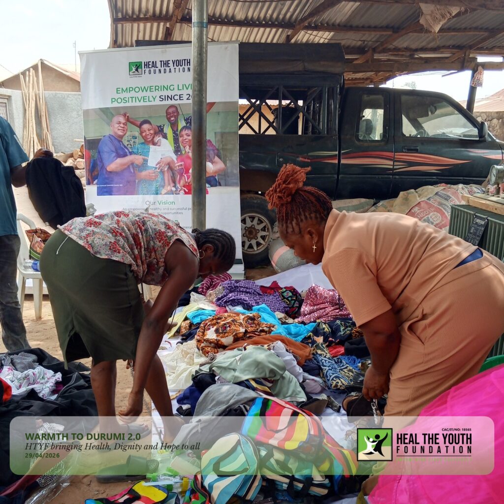 Some beneficiary supported by the Outreach Volunteer sorting our clothes.